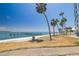 Waterfront view with palm trees and a fishing pier at 7200 Sunshine Skyway S Ln # 4B, St Petersburg, FL 33711