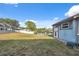 Backyard of home leading to screened-in patio and a lake at 7325 Calder Dr, New Port Richey, FL 34653