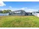 Lush backyard with a screened enclosure, ideal for outdoor relaxation and entertainment at 7325 Calder Dr, New Port Richey, FL 34653