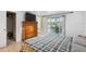 Bedroom featuring wood dresser, closet, and sliding glass door access to outdoor living space at 7325 Calder Dr, New Port Richey, FL 34653