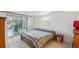 Cozy bedroom with tiled flooring, a comfortable bed, and sliding glass doors leading to the outdoors at 7325 Calder Dr, New Port Richey, FL 34653
