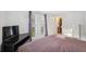 Bright bedroom featuring two windows with blinds, a television, and a closet at 7325 Calder Dr, New Port Richey, FL 34653