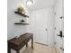 Inviting entryway with modern white brick accent wall, floating shelves, and dark wood console table at 7325 Calder Dr, New Port Richey, FL 34653