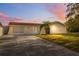 Inviting single-story home featuring a long driveway and a well-maintained lawn with a small palm tree at 7325 Calder Dr, New Port Richey, FL 34653