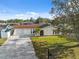 Charming single-story home with a well-manicured lawn, and long driveway at 7325 Calder Dr, New Port Richey, FL 34653