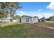 View of home exterior with stucco walls and landscaped front yard at 7325 Calder Dr, New Port Richey, FL 34653