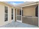 Screened-in outdoor patio featuring durable flooring and bright natural light filtering through the windows at 7325 Calder Dr, New Port Richey, FL 34653