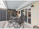 Enclosed patio area featuring an outdoor table and chairs, and view to the yard at 7325 Calder Dr, New Port Richey, FL 34653