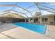 Enclosed pool area featuring a spacious pool with ample lounging space and clear overhead coverage at 7325 Calder Dr, New Port Richey, FL 34653