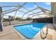 Enclosed pool area with clear blue water, offering a refreshing and private outdoor space at 7325 Calder Dr, New Port Richey, FL 34653