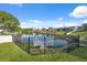 Scenic waterfront view with a well-maintained lawn and a black metal fence at 7325 Calder Dr, New Port Richey, FL 34653