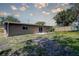 Backyard of the home, with a concrete patio and playhouse at 8497 137Th St, Seminole, FL 33776