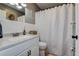 Cozy bathroom with a single sink vanity, framed mirror, and shower tub combination with white tiling at 8497 137Th St, Seminole, FL 33776