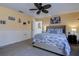 Bedroom with a queen bed, beach decor, ceiling fan and neutral carpet at 8497 137Th St, Seminole, FL 33776