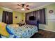 Bedroom featuring a ceiling fan, TV, and bright, colorful decor at 8497 137Th St, Seminole, FL 33776