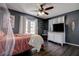 Bedroom with dark gray walls, white trim, hardwood flooring, and French doors at 8497 137Th St, Seminole, FL 33776
