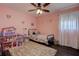 Pink bedroom with wood floors, lots of toys, and sheer curtains at 8497 137Th St, Seminole, FL 33776