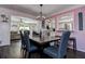 Dining room featuring a wooden table with seating, accented by nautical decor and flowing into the kitchen at 8497 137Th St, Seminole, FL 33776
