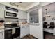 Well-equipped kitchen with modern appliances, neutral cabinetry, and a convenient pass-through to the dining area at 8497 137Th St, Seminole, FL 33776