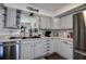 Charming kitchen featuring white cabinets, stainless steel appliances, and a functional layout, great for cooking at 8497 137Th St, Seminole, FL 33776