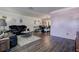 Open-concept living and dining area with dark wood floors, plush seating, and stylish decor at 8497 137Th St, Seminole, FL 33776
