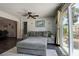 Bright living room with ceiling fan and large sliding glass doors that lead to an outdoor seating area at 8497 137Th St, Seminole, FL 33776