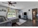 Cozy living room featuring a comfy gray sofa and sliding glass doors leading to the backyard at 8497 137Th St, Seminole, FL 33776