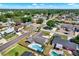 Aerial view of the home with a screened in patio and in-ground pool in a residential neighborhood at 8520 Woodall Ct, Tampa, FL 33615