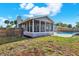 Landscaped backyard featuring a screened in patio, fenced in area, and view of the kidney-shaped pool at 8520 Woodall Ct, Tampa, FL 33615