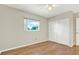Cozy bedroom with wood floors, a window for natural light, and a closet for storage at 8520 Woodall Ct, Tampa, FL 33615