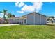 Well-maintained gray single-story home featuring a covered porch and green lawn at 8520 Woodall Ct, Tampa, FL 33615
