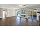 Spacious living room with hardwood floors, sliding doors, and views of the pool at 8520 Woodall Ct, Tampa, FL 33615
