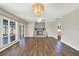 An inviting living room with wood floors, a striking fireplace, and elegant chandelier at 8520 Woodall Ct, Tampa, FL 33615