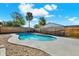 Inviting kidney-shaped pool, surrounded by concrete and pebble accents, nestled within a wood-fenced backyard at 8520 Woodall Ct, Tampa, FL 33615