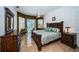 Comfortable main bedroom features luxury furniture and poolside views at 8926 Garner Ct, Trinity, FL 34655