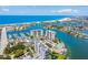 Stunning aerial view of waterfront condos with beach access, marina, and lush landscaping at 9425 Blind Pass Rd # 802, St Pete Beach, FL 33706