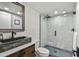Updated bathroom featuring stone accent wall, vessel sink, and walk-in shower at 9425 Blind Pass Rd # 802, St Pete Beach, FL 33706