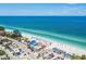 Beautiful white sand beach with clear turquoise water and beachfront amenities at 9425 Blind Pass Rd # 802, St Pete Beach, FL 33706