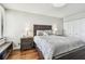 Serene bedroom featuring a comfortable queen bed, a stylish nightstand, and wood flooring for a relaxing ambiance at 9425 Blind Pass Rd # 802, St Pete Beach, FL 33706