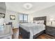 Comfortable bedroom features hardwood floors, a stylish queen bed, a writing desk, and a scenic window with city views at 9425 Blind Pass Rd # 802, St Pete Beach, FL 33706