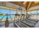 Well-equipped fitness center with treadmills and views of the pool and waterfront at 9425 Blind Pass Rd # 802, St Pete Beach, FL 33706