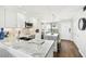 Bright, open kitchen with island, marble countertops, stainless steel appliances, and wood floors at 9425 Blind Pass Rd # 802, St Pete Beach, FL 33706