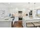 Bright, open kitchen with island, marble countertops, stainless steel appliances, and wood floors at 9425 Blind Pass Rd # 802, St Pete Beach, FL 33706