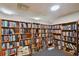 Community library featuring floor to ceiling wooden book shelves with a vast array of reading options at 9425 Blind Pass Rd # 802, St Pete Beach, FL 33706