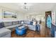 Inviting living area with hardwood floors, modern lighting, comfortable seating and views into the open-concept kitchen at 9425 Blind Pass Rd # 802, St Pete Beach, FL 33706