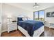 Comfortable primary bedroom featuring a large window, hardwood floors, ensuite and white furniture accents at 9425 Blind Pass Rd # 802, St Pete Beach, FL 33706