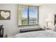 Close-up of a window with bright views of the city featuring a nightstand and lamp at 9425 Blind Pass Rd # 802, St Pete Beach, FL 33706