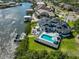 Waterfront home featuring an inviting backyard pool, patio area, and private dock at 945 Bunker View Dr, Apollo Beach, FL 33572