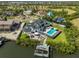Aerial view showcasing a backyard pool, patio, and dock on the water at 945 Bunker View Dr, Apollo Beach, FL 33572
