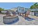 Inviting backyard with fire pit, hot tub, and outdoor bar, ideal for entertaining guests in a relaxed atmosphere at 945 Bunker View Dr, Apollo Beach, FL 33572
